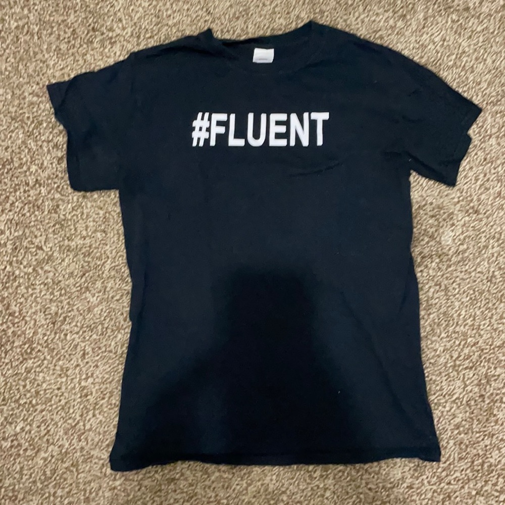 Black shirt that says #fluent on it